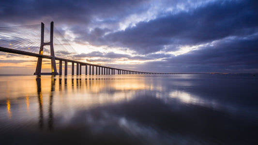 Vasco da Gama Bridge at sunrise mirrored in the still Tagus, Lisbon, Portugal — fine art photography print by Martin Sojka