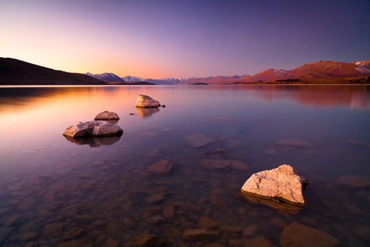 Clear water, stones and last light on the Southern Alps at Lake Tekapo, New Zealand — fine art photography print by Martin Sojka